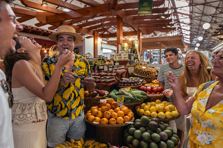 Tasting fruit at local Market in Madeira Island
